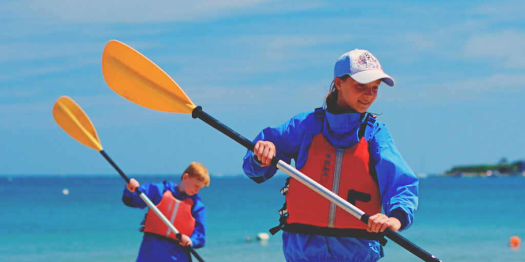 Two Children Kayaking in Sandbanks on one of the Land and Wave Year 7 Activity Days