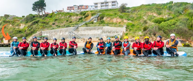 Adventure group sitting on large SUP boards