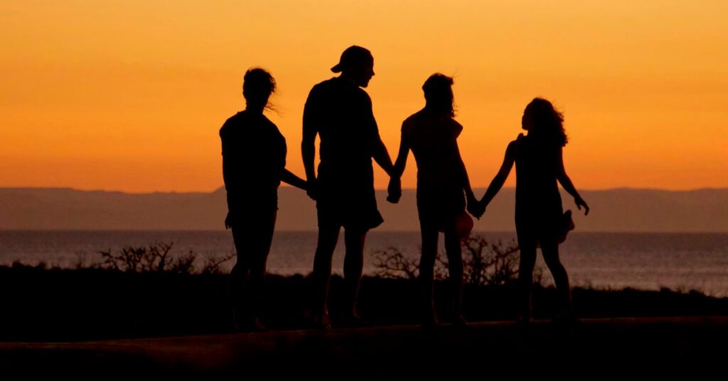 A group of people enjoying a sunset