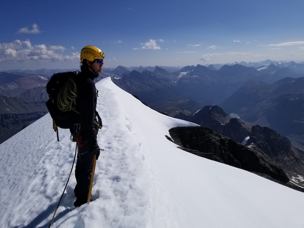 Mountaineer on top of a mountain in Canada