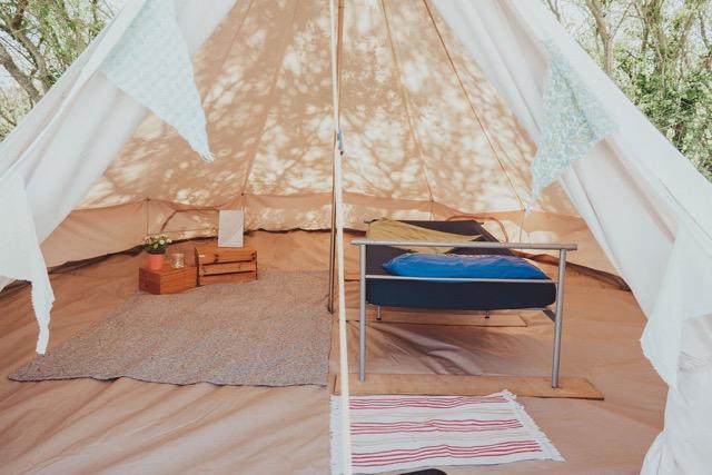 Bell tent set up by a camp assistant 