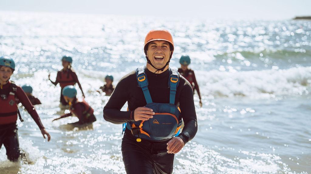 instructor smiling and walking out of the sea