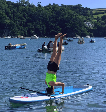 Women upside down on a paddle board Adventure