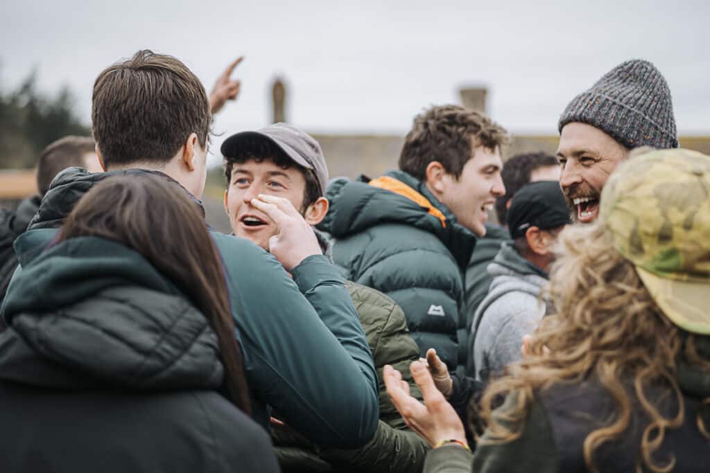 A group of outdoor instructors engage in a problem solving game