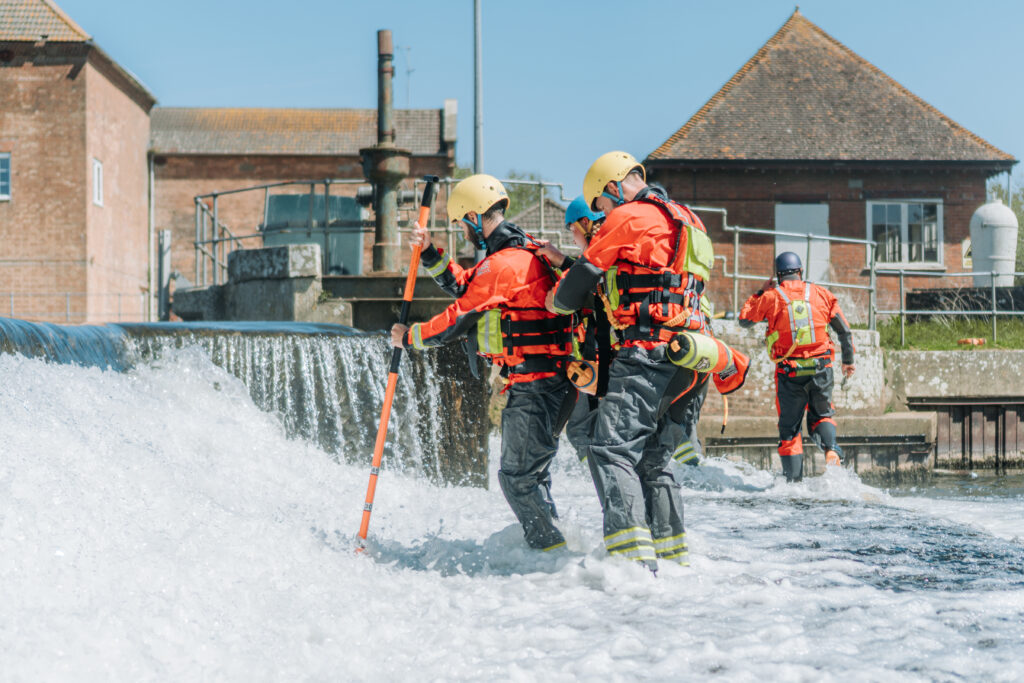 Group of Construction Workers Wading across water