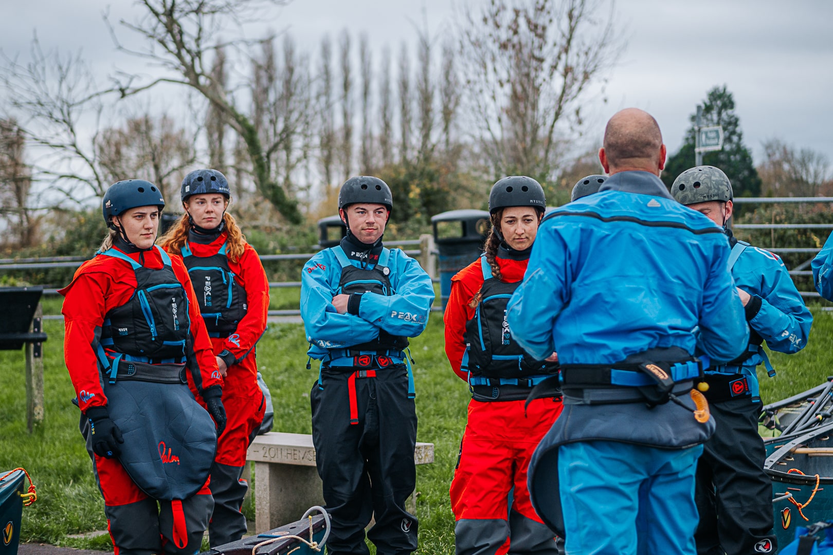 Teacher looking towards group, teaching about kayaking. This is an example of using a AET qualification